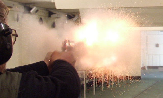 .45 calibre stainless steel revolver being fired